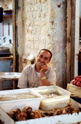 A smiling meat seller