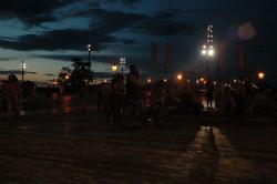 People crowd around listening to a busker singing opera