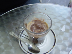 A coffee treat -- ice cream in a shot of espresso. This is known as Affogato al Caffe in Italian.