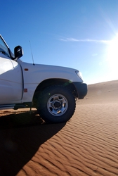 The 4x4 on a dune, near the Sacred Source in the desert