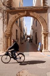A cyclist inside Essaouira's medina